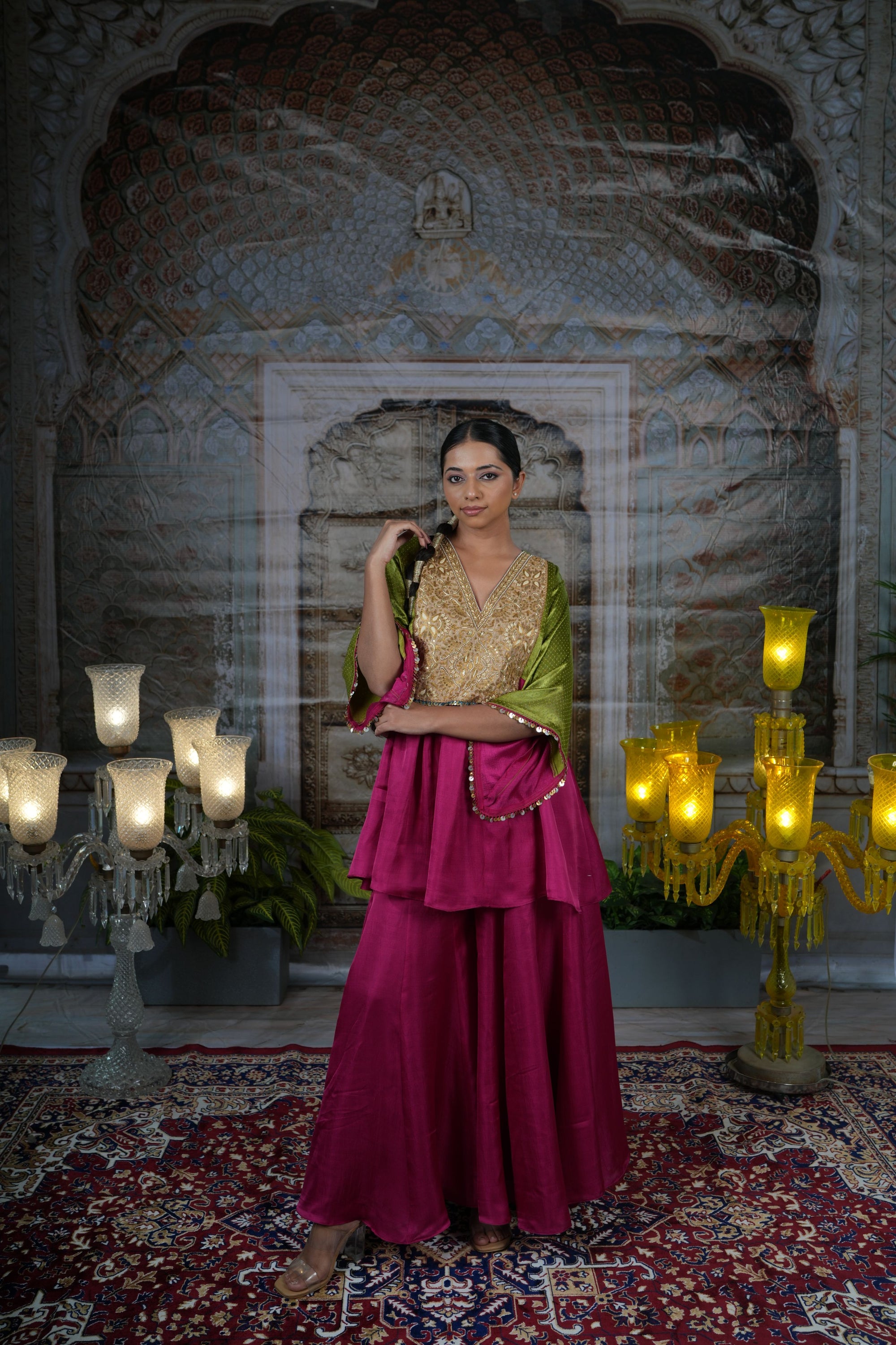 Pink top with gold yoke, paired with flared pants