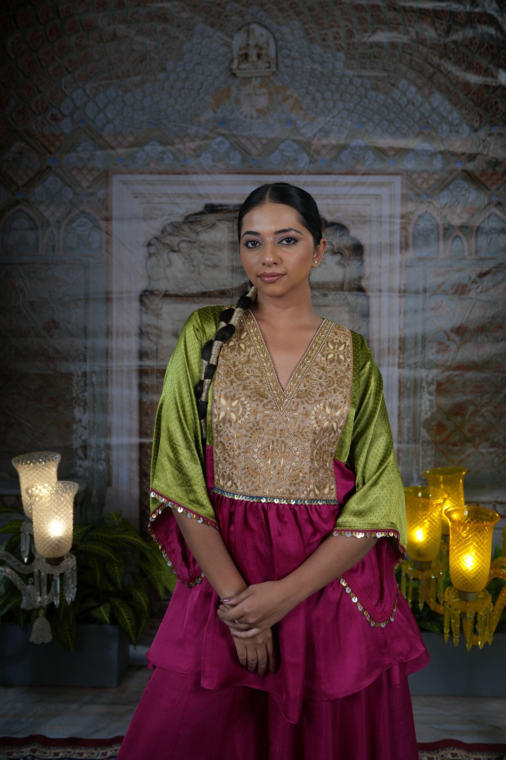 Pink top with gold yoke, paired with flared pants