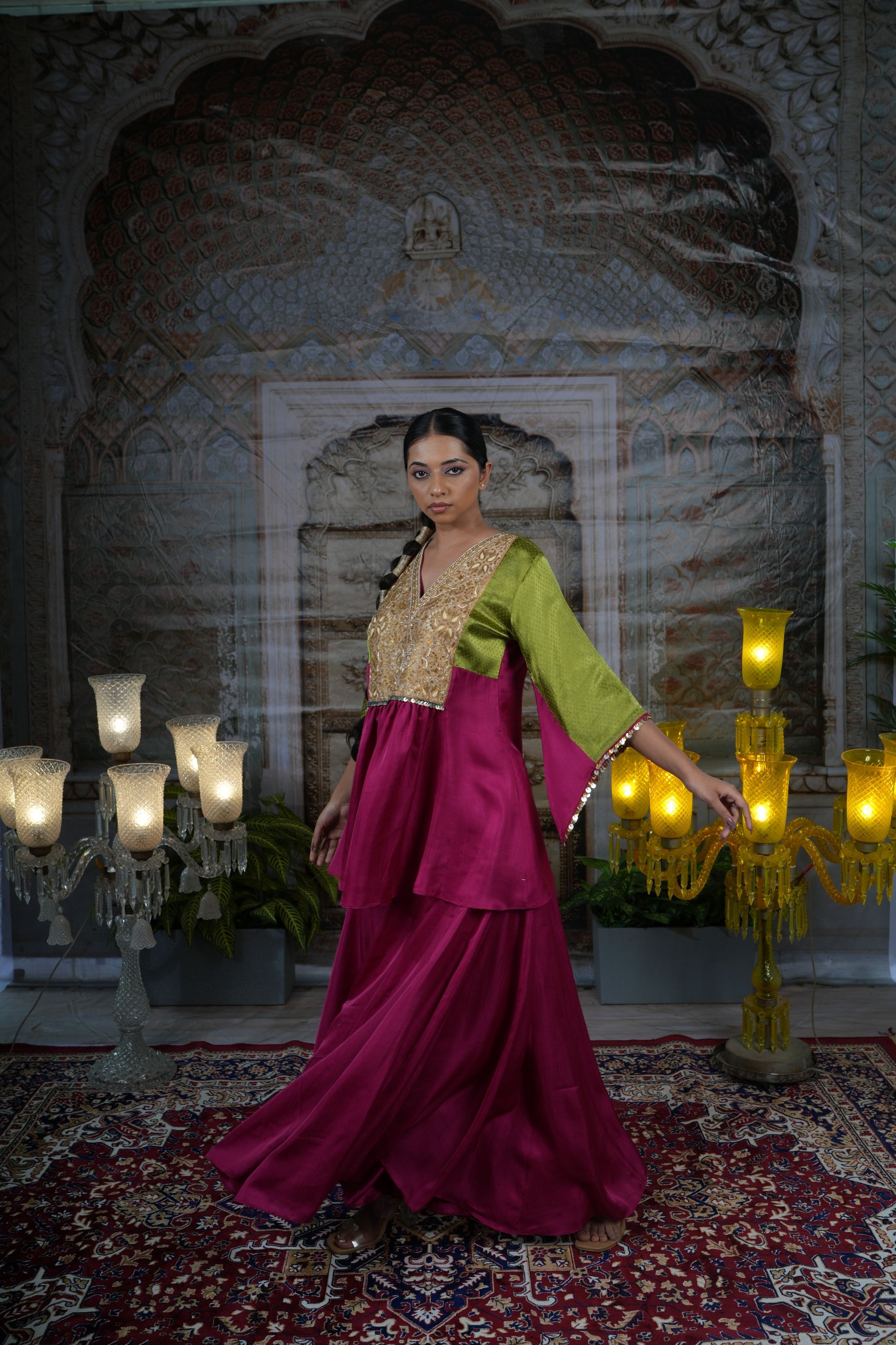 Pink top with gold yoke, paired with flared pants