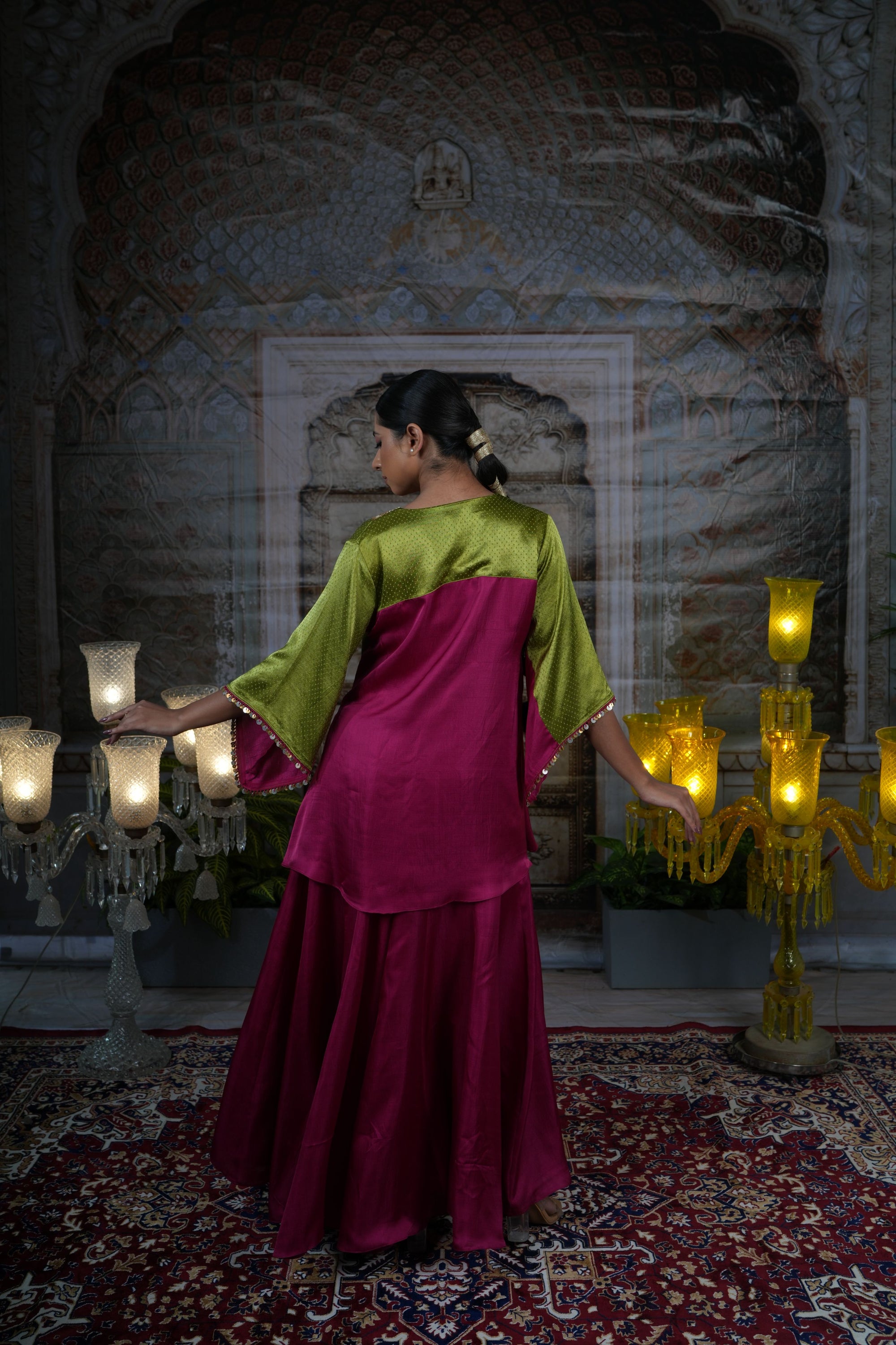 Pink top with gold yoke, paired with flared pants