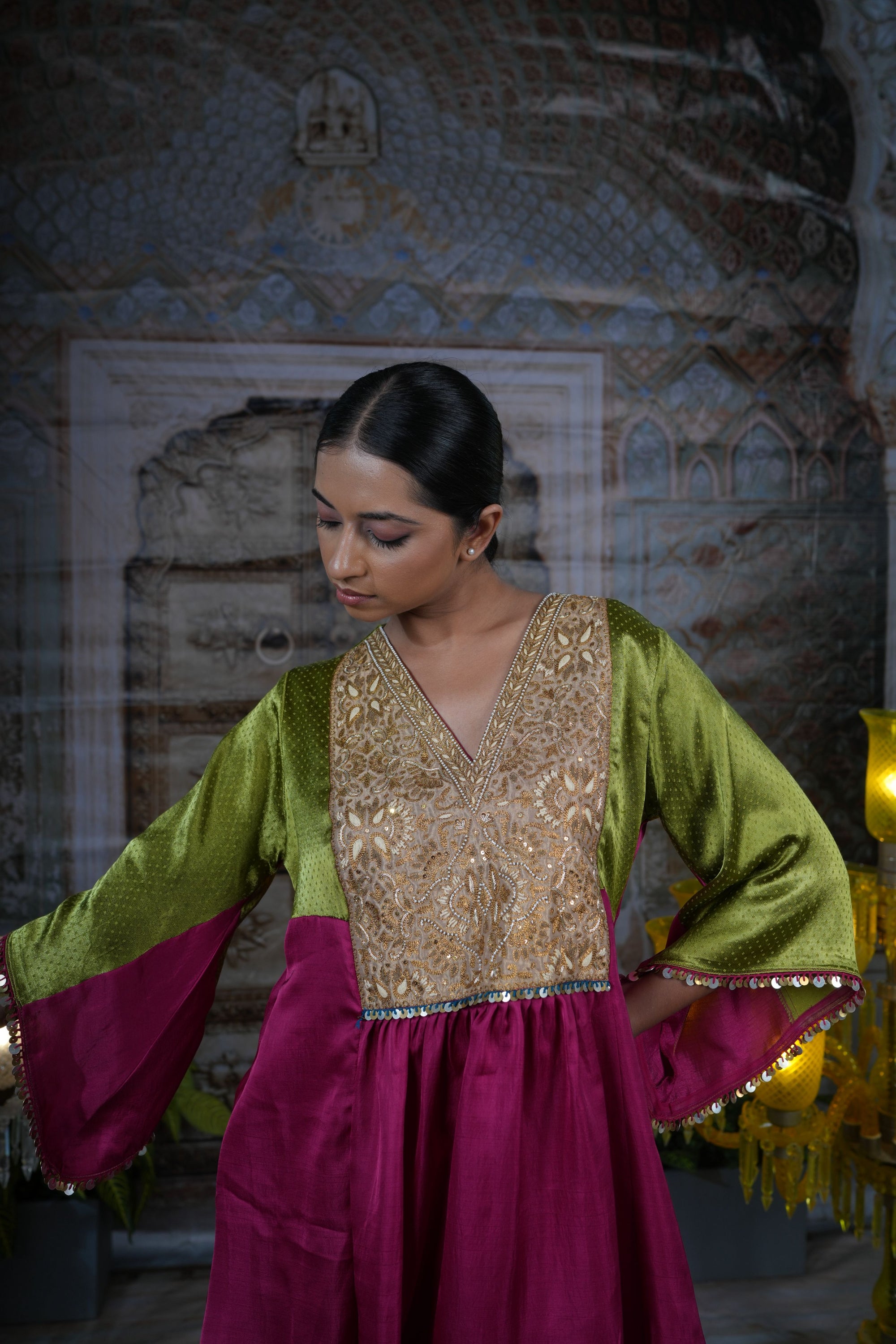 Pink top with gold yoke, paired with flared pants