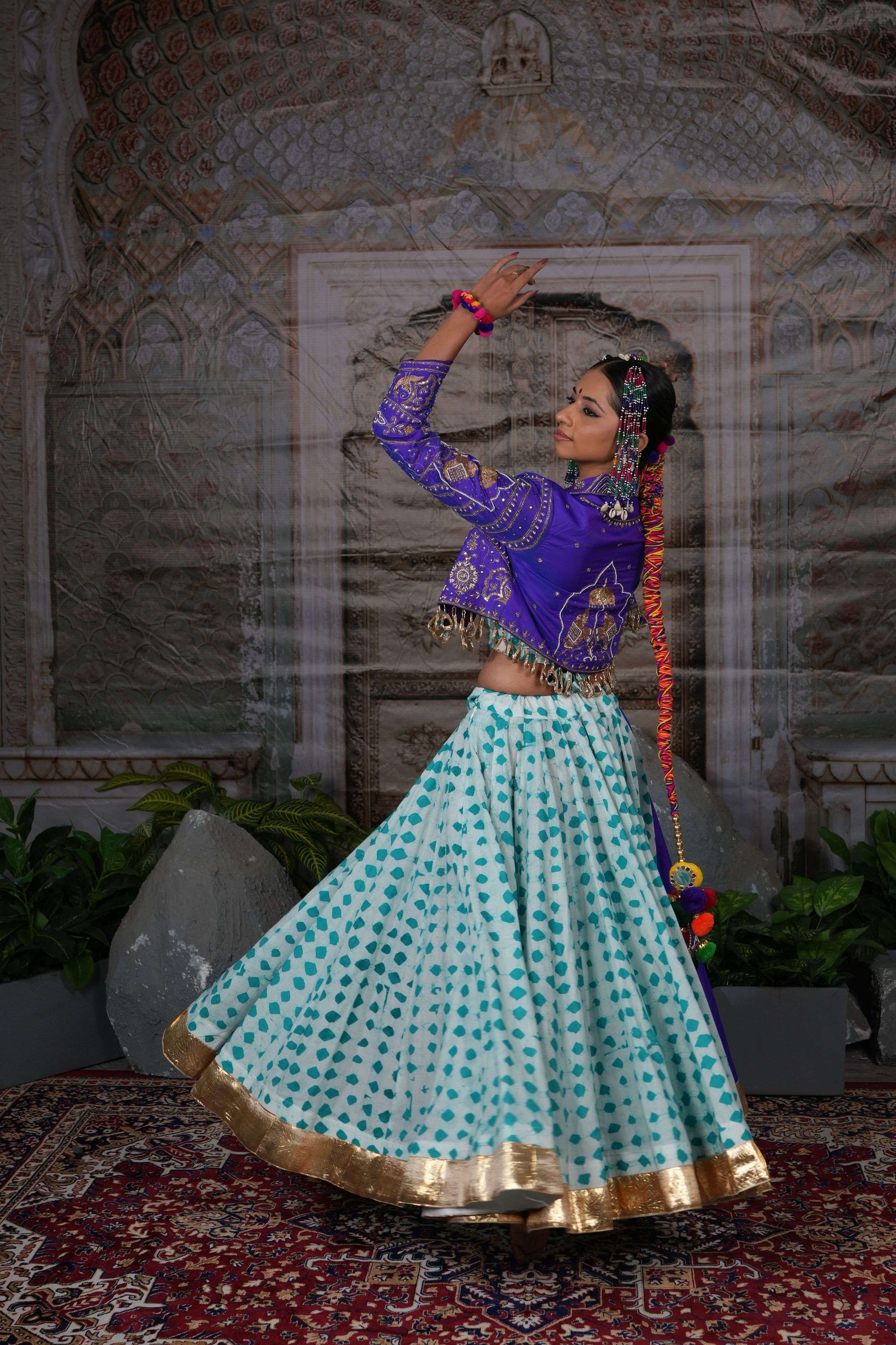 Printed flared lehenga with hand embroidered jacket with mirror latkans